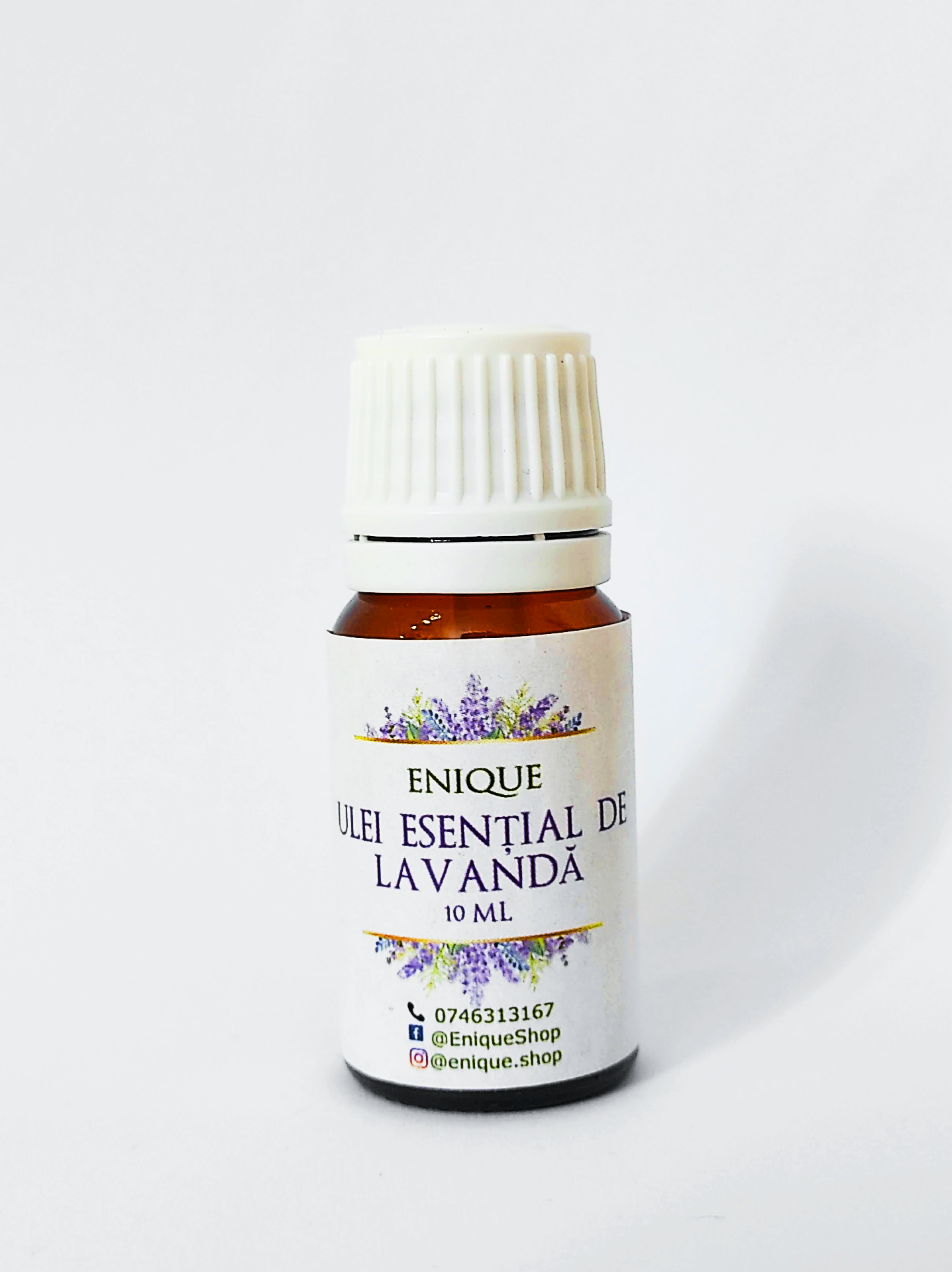 Bottle of Enique lavender essential oil on a white background